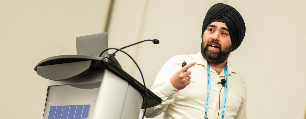 Parminder Singh presenting on building durable autonomous agents at AI Council 2026, standing at a podium with the AI Council logo