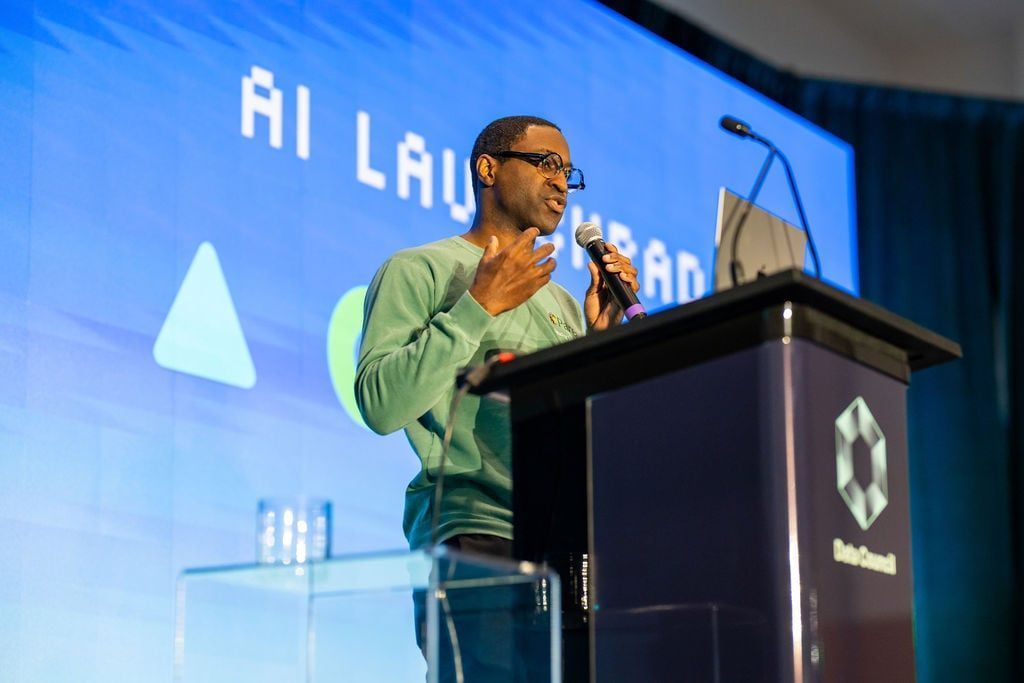 Speaker on stage at AI Council 2026 presenting under an AI Launchpad backdrop