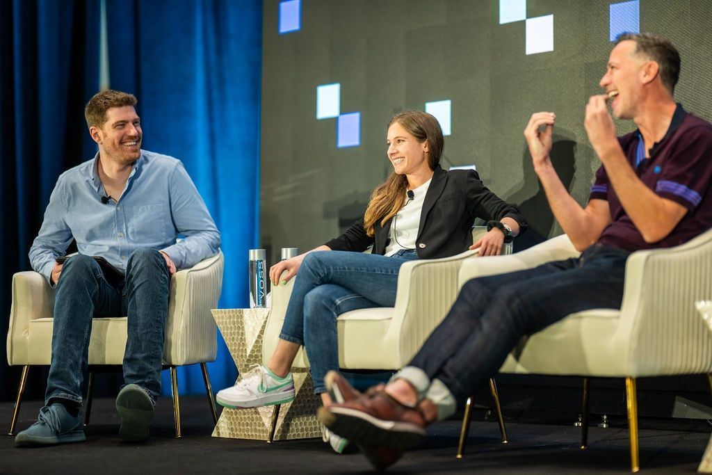 Three panelists seated on stage at AI Council 2026 during a panel discussion